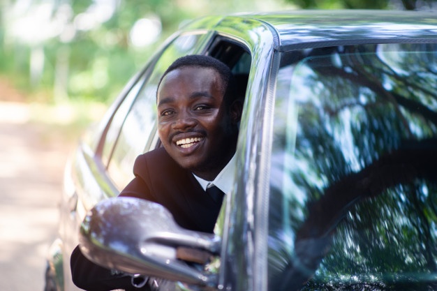 business-man-driving-smiling-while-sitting-car-with-open-front-window_73622-273